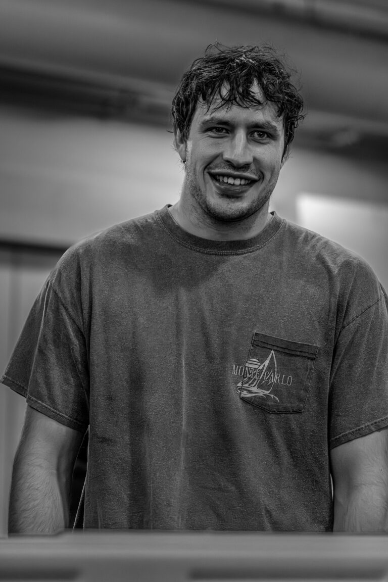 Zachary Alatorre-Davies, a smiling man with wet hair in a Monte Carlo shirt.